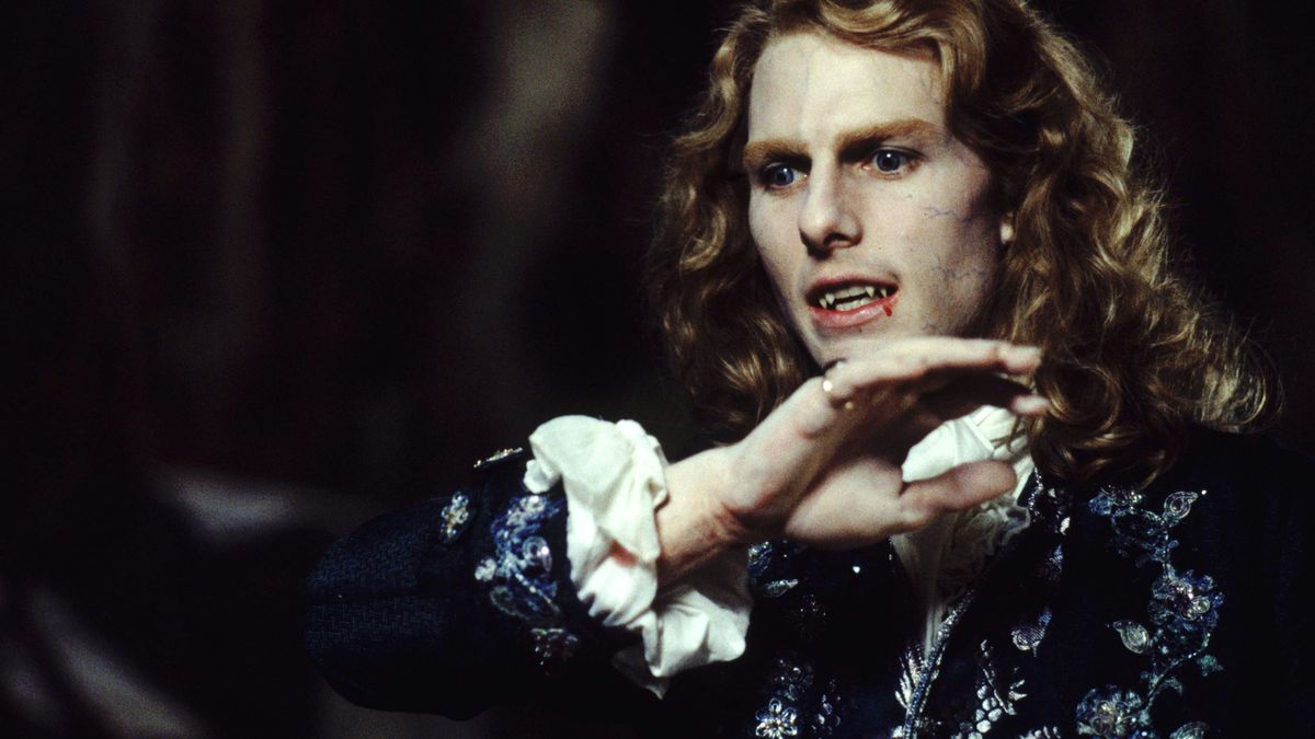 Tom Cruise as Lestat in Interview With the Vampire, with long curly blond hair and blood dripping from his mouth