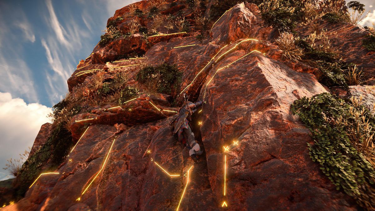 Aloy si arrampica su una scogliera, con linee gialle luminose sovrapposte alla parete rocciosa, in Horizon Forbidden West