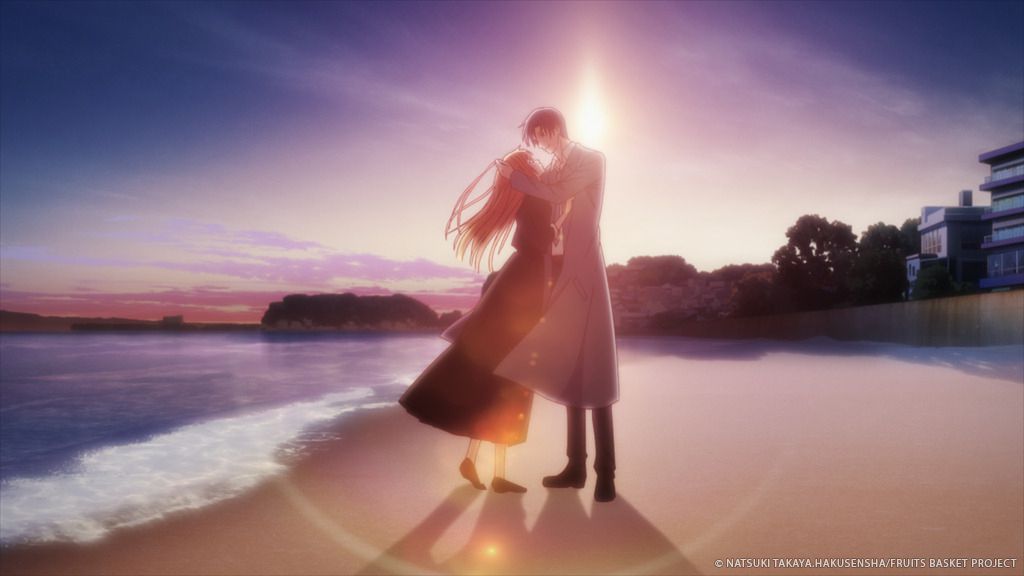 katsuya e kyoko sulla spiaggia, un sole al tramonto dietro di loro 