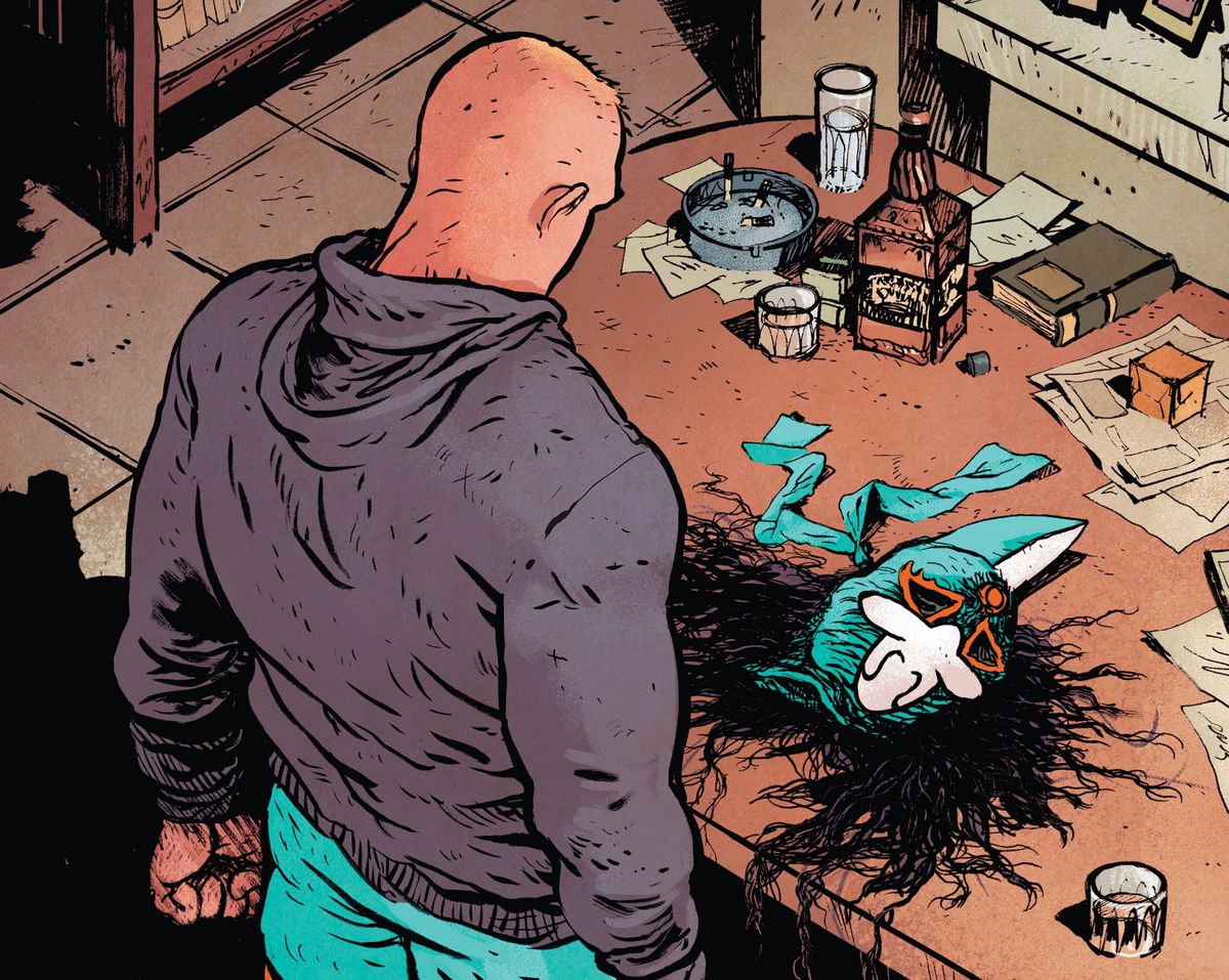 Un uomo biondo in uniforme da wrestling e felpa con cappuccio si trova su un tavolo cosparso di carte, bicchieri di whisky, sigarette e una maschera da luchador in Do a Powerbomb # 2 (2022). 