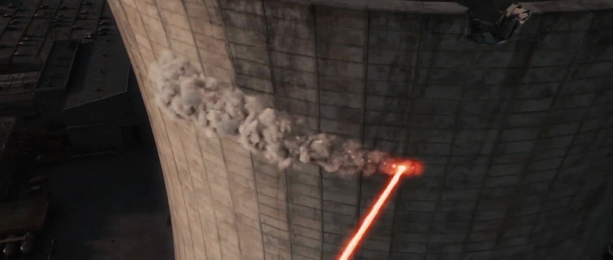 I laser ancora accesi di Deadpool tracciano una linea di distruzione attraverso il cemento della ciminiera della centrale nucleare in X-Men Origins: Wolverine.