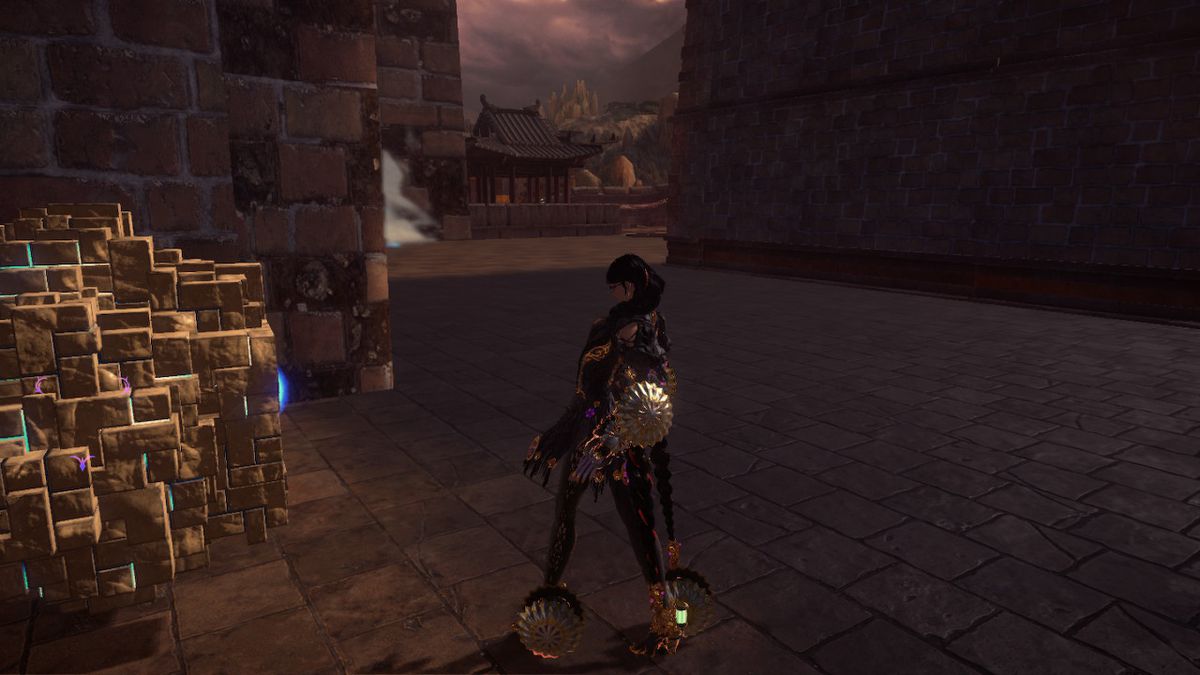 Bayonetta si trova vicino a un cuore di strega spezzato tra due strutture in pietra in Bayonetta 3.
