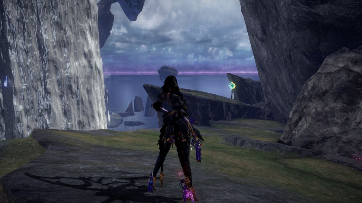 Bayonetta si trova su una scogliera e guarda l'orizzonte in Bayonetta 3.