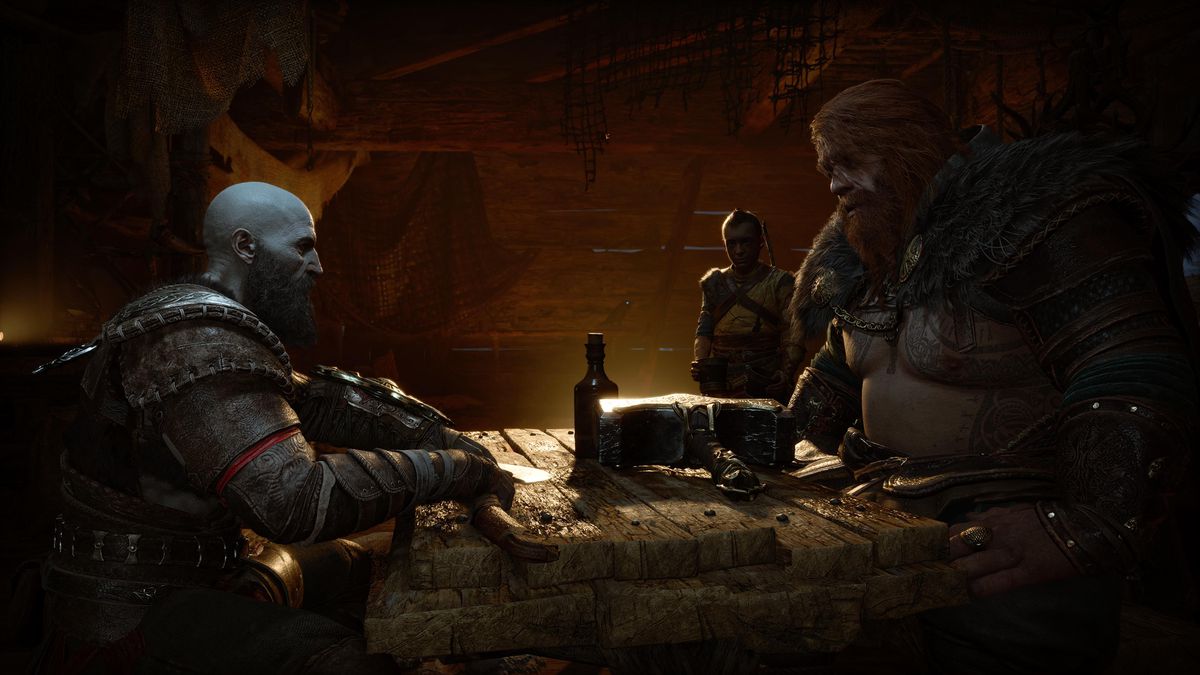 Kratos e Thor parlano al tavolo con Atreus sullo sfondo in God of War Ragnarök