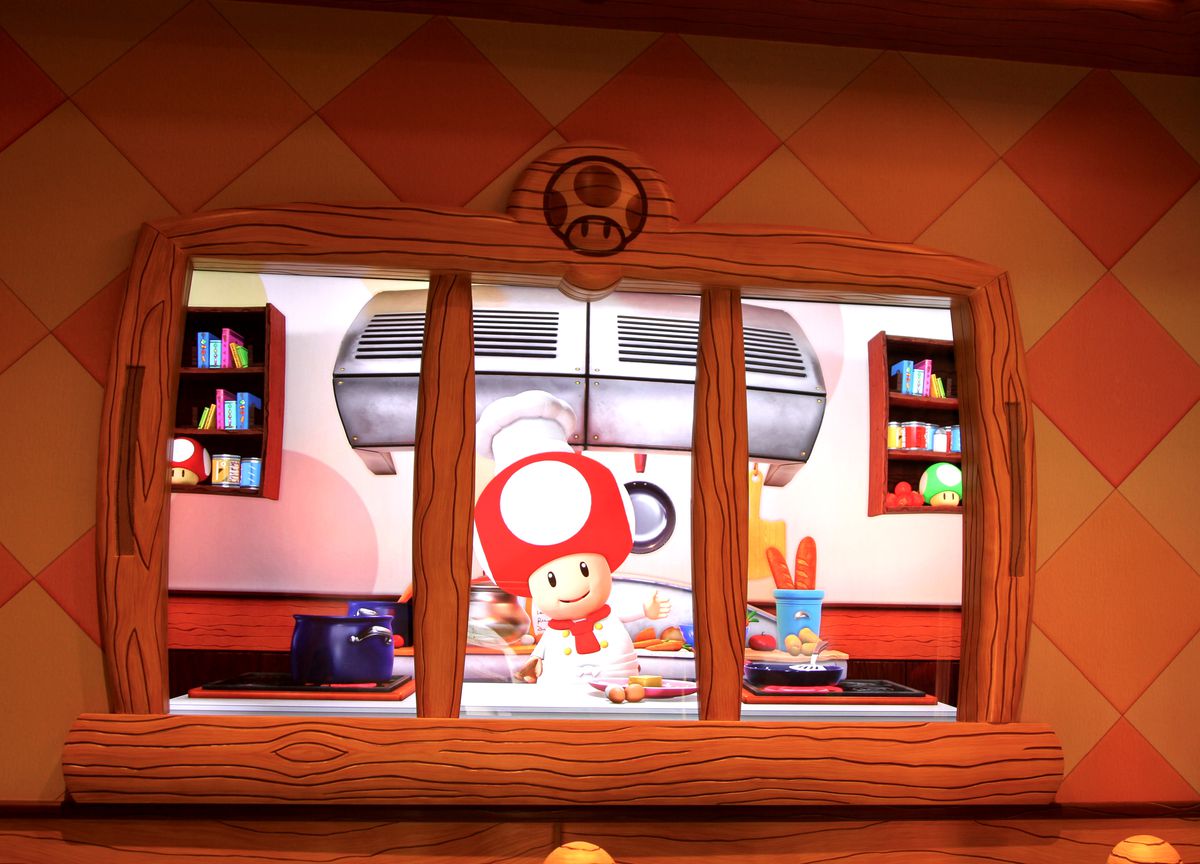 Chef Toad saluta i visitatori al Toadstool Cafe al Super Nintendo World