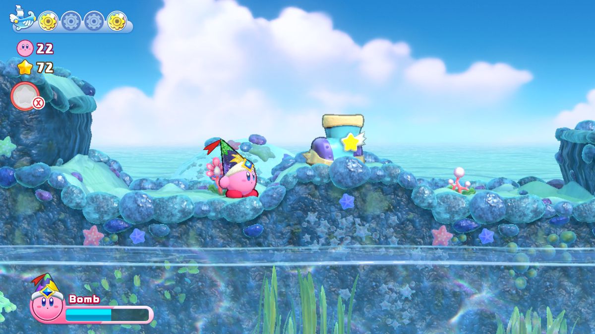 Kirby naviga sulla superficie di un mondo di barriera corallina in Kirby's Return to Dreamland Deluxe
