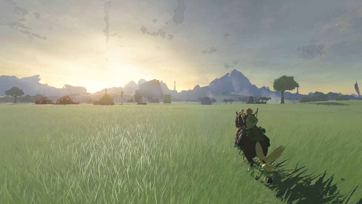 Uno screenshot di The Legend of Zelda: Tears of the Kingdom di Link che cavalca un cavallo attraverso un campo erboso a Hyrule