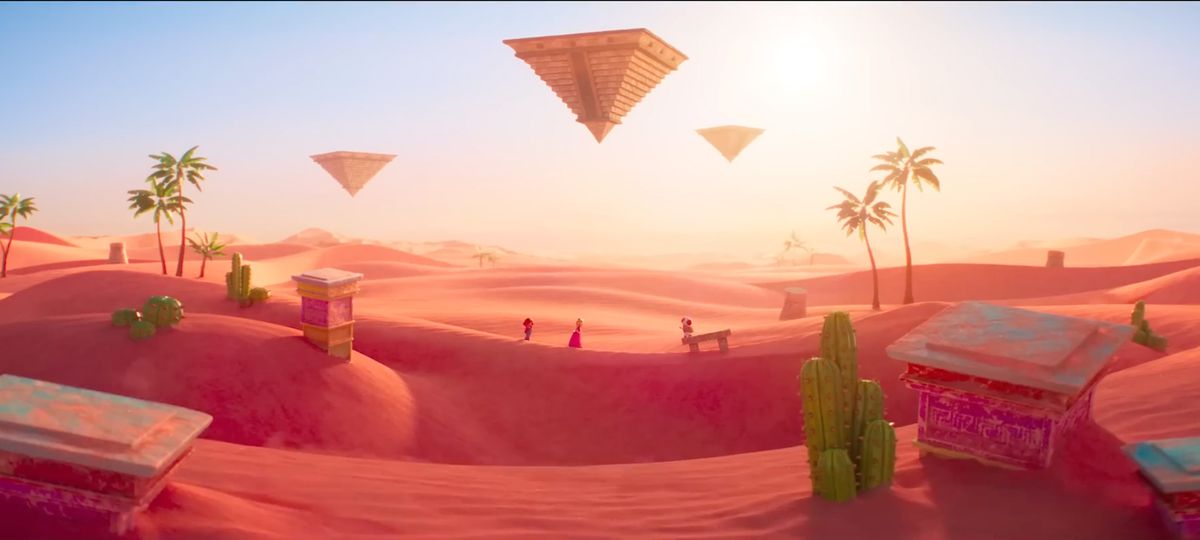 Un'immagine panoramica del Regno di Sabbia dal film Super Mario Bros..  Mario, Peach e Toad attraversano una duna di sabbia sullo sfondo.
