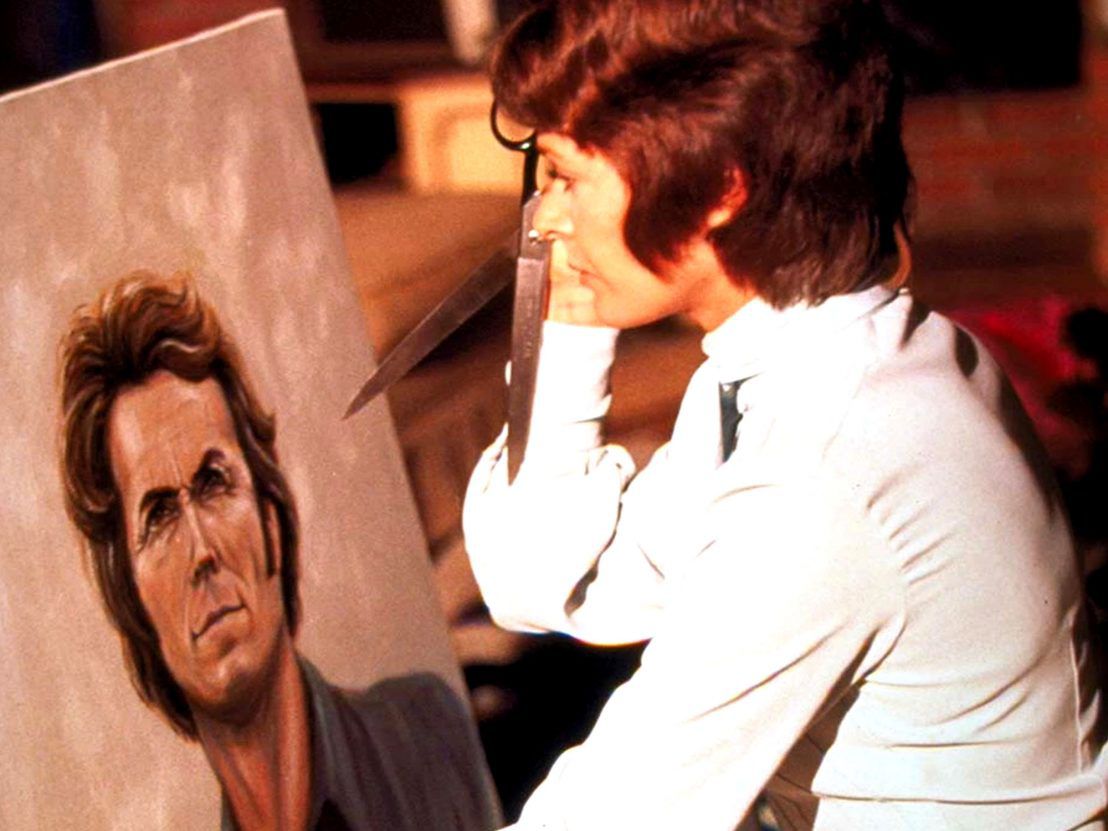 Evelyn (Jessica Walter) tiene in mano un paio di forbici contro un ritratto su tela del disc jockey Dave (Clint Eastwood) in Play Misty For Me