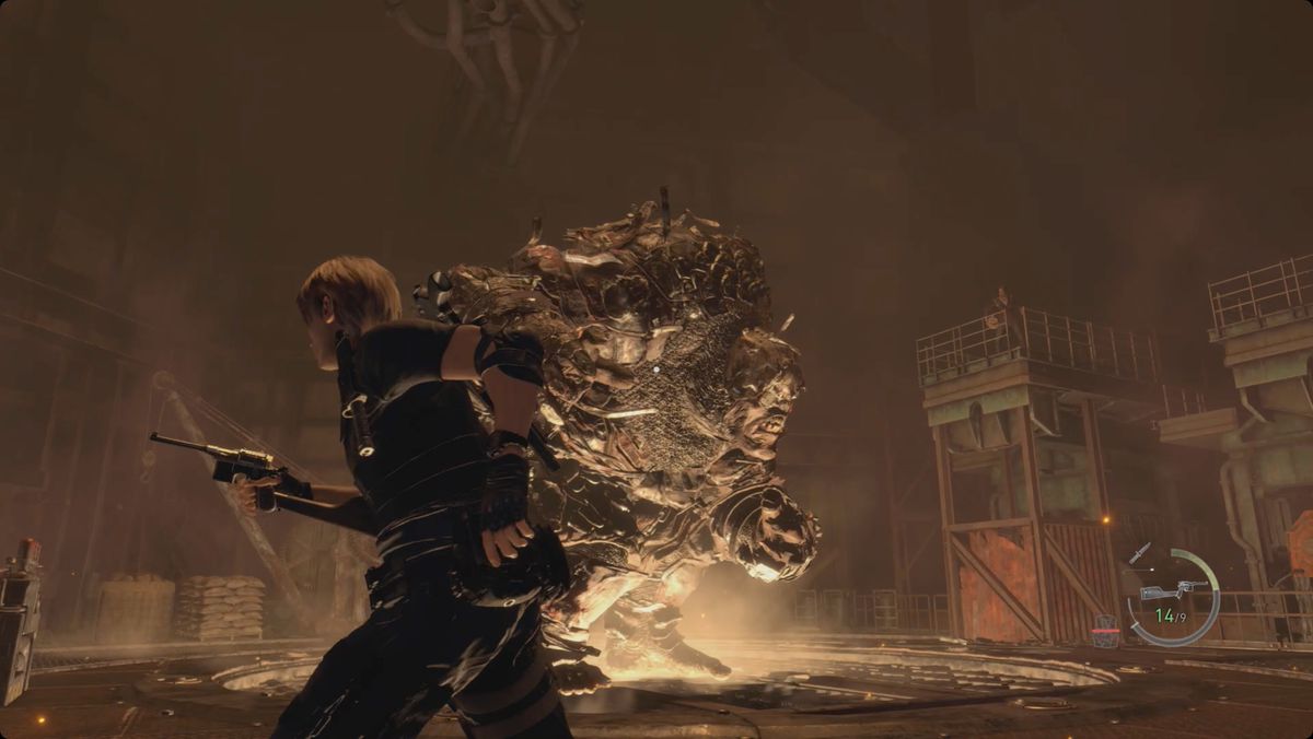 Resident Evil 4 remake Leon che combatte il gigante corazzato nell'altoforno.  Luis è in piedi su una torre vicina con un fascio di dinamite.
