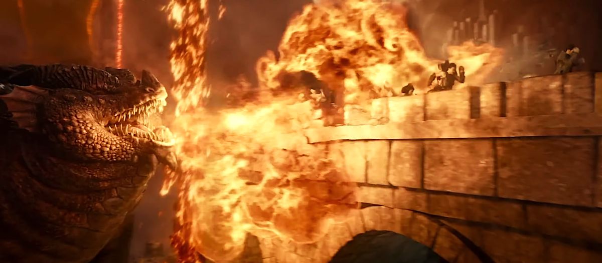 Themberchaud il grande drago boi che soffia fuoco a una festa mentre corrono attraverso un ponte nel film Dungeons & Dragons