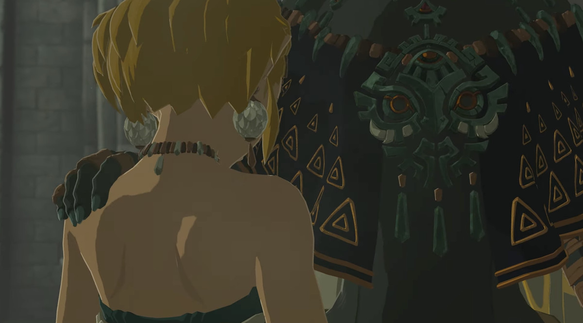 Un'immagine dal trailer di The Legend of Zelda: Tears of the Kingdom.  Mostra una persona alta che mette la mano sulla spalla di Zelda, ma non possiamo vedere la sua faccia. 