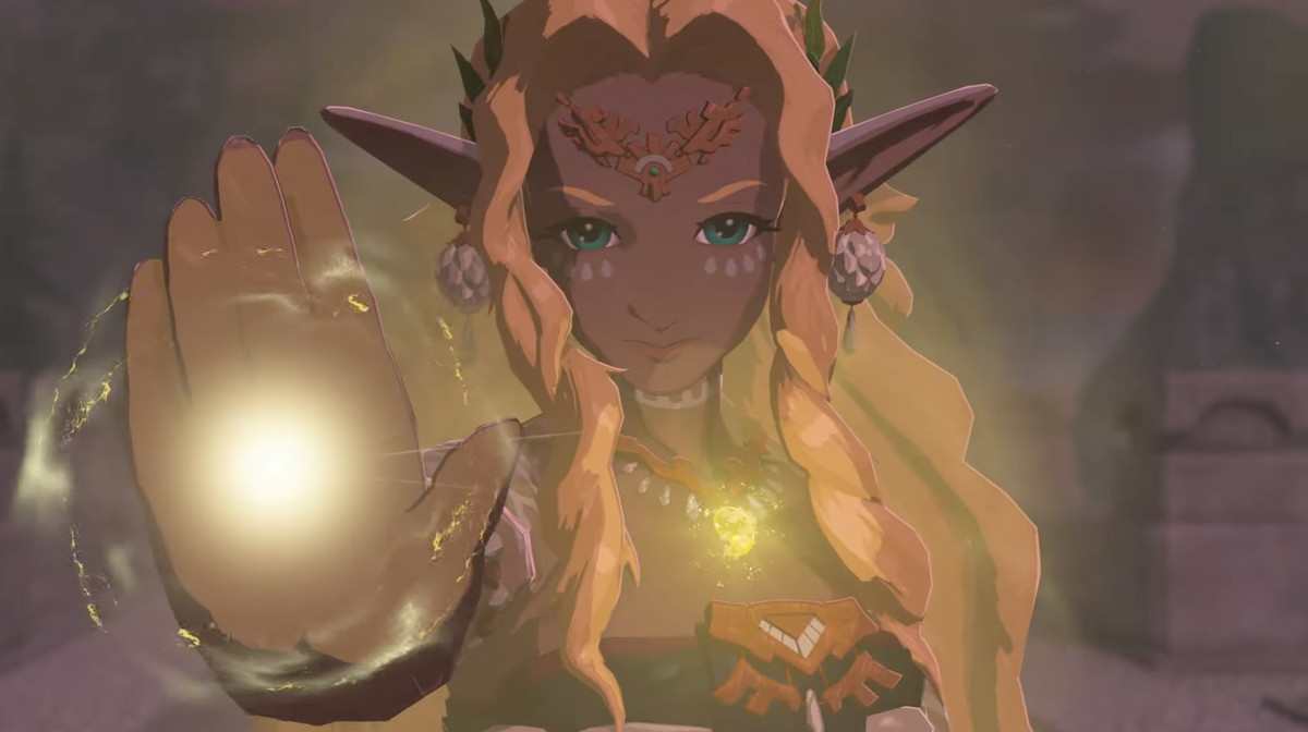 Un'immagine di un personaggio simile a un elfo di The Legend of Zelda: Tears of the Kingdom.  Hanno i capelli lunghi e le orecchie lunghe e appuntite.  La loro mano è di un giallo brillante, così come la loro collana mentre guardano determinati nella telecamera.