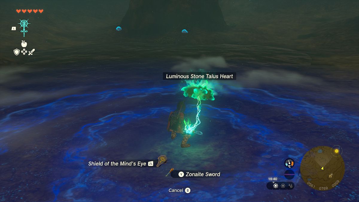 Link fonde un cuore di talus di pietra luminosa con un'arma in una caverna in Zelda Tears of the Kingdom.