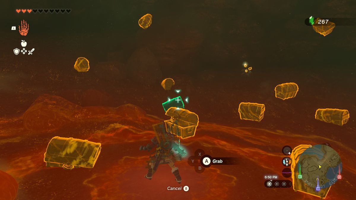 Link usa Ultrahand e mira a una cassa in fondo alla caverna, che è conficcata nel terreno, in Zelda: Tears of the Kingdom