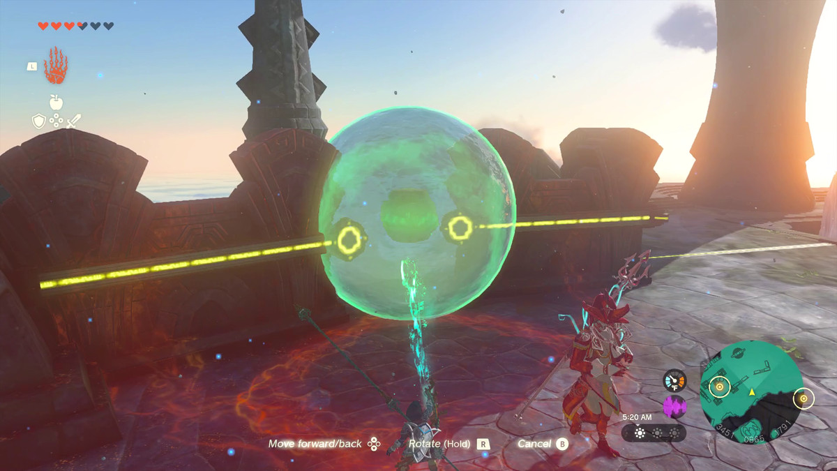 Una grande sfera d'acqua galleggia sopra un cerchio rosso e si illumina di verde alla luce dell'abilità Ultramano di Link.  Cavi elettrici appena dentro dal suo lato sinistro e destro.