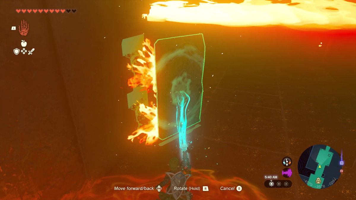 The Legend of Zelda: Tears of the Kingdom Link usa Ultrahand per bloccare alcune fiamme con un pannello di pietra