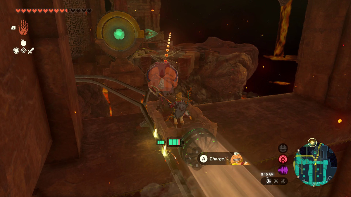 In Tears of the Kingdom, Link guida un carrello da miniera alimentato da un ventilatore e punta Yunobo verso un altro meccanismo rotondo con una freccia che punta a destra