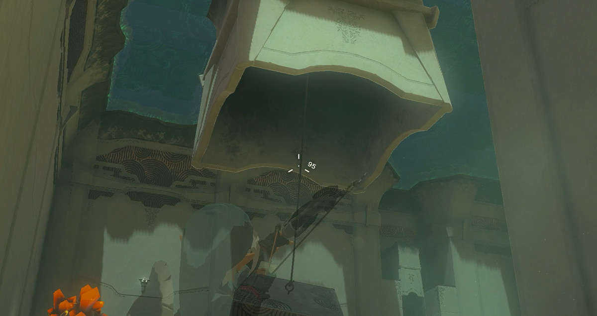 Link che punta una freccia contro una corda che pende dal soffitto in Zelda: Tears of the Kingdom.