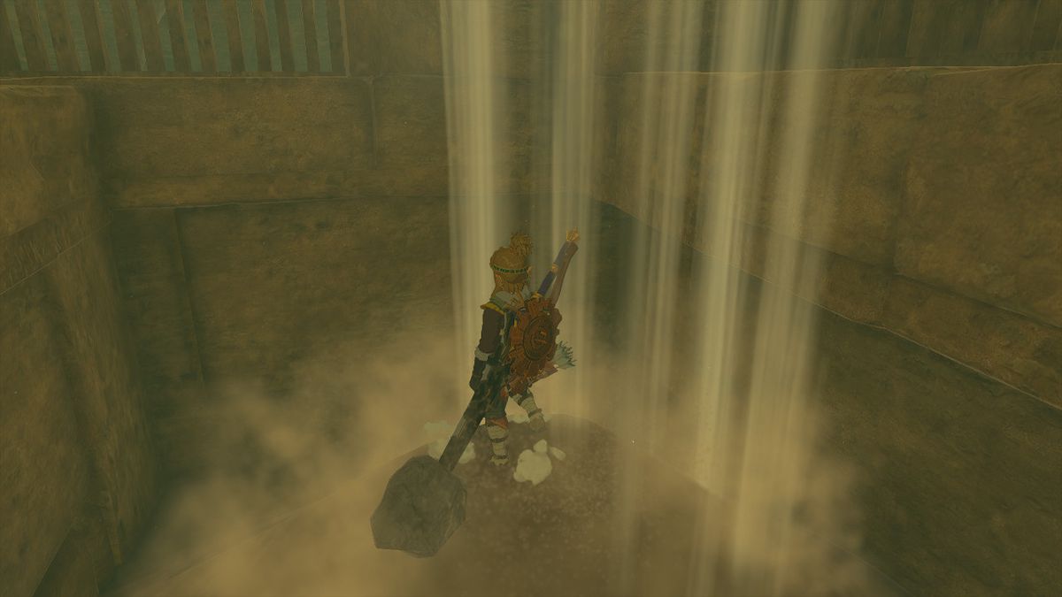 Link si trova su un pilastro sotto una cascata di sabbia in Zelda Tears of the Kingdom.
