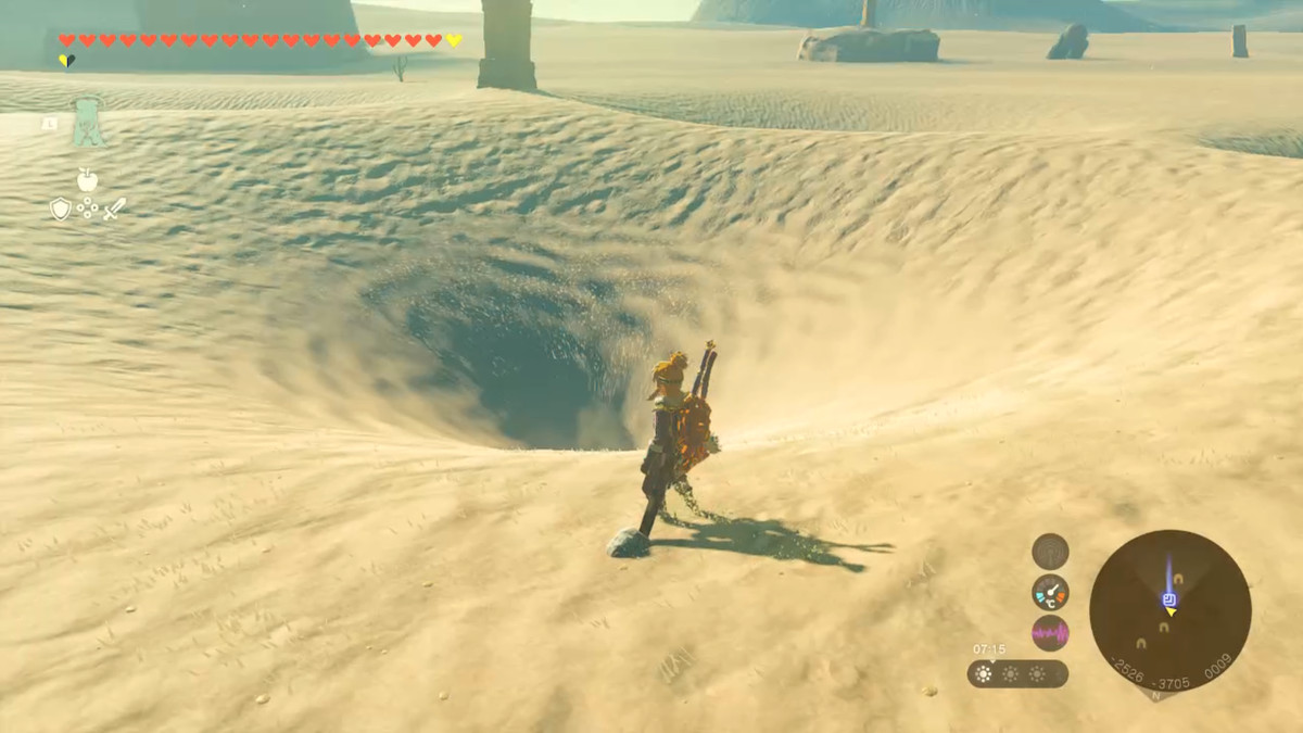 Link si trova accanto a un vortice nella sabbia in Zelda Tears of the Kingdom.