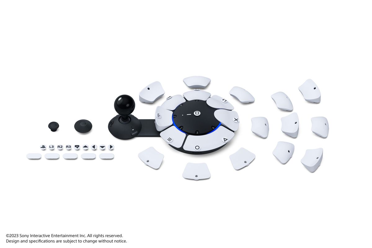 Una foto del prodotto del controller di accesso, un dispositivo circolare bianco con una serie di pulsanti intercambiabili.