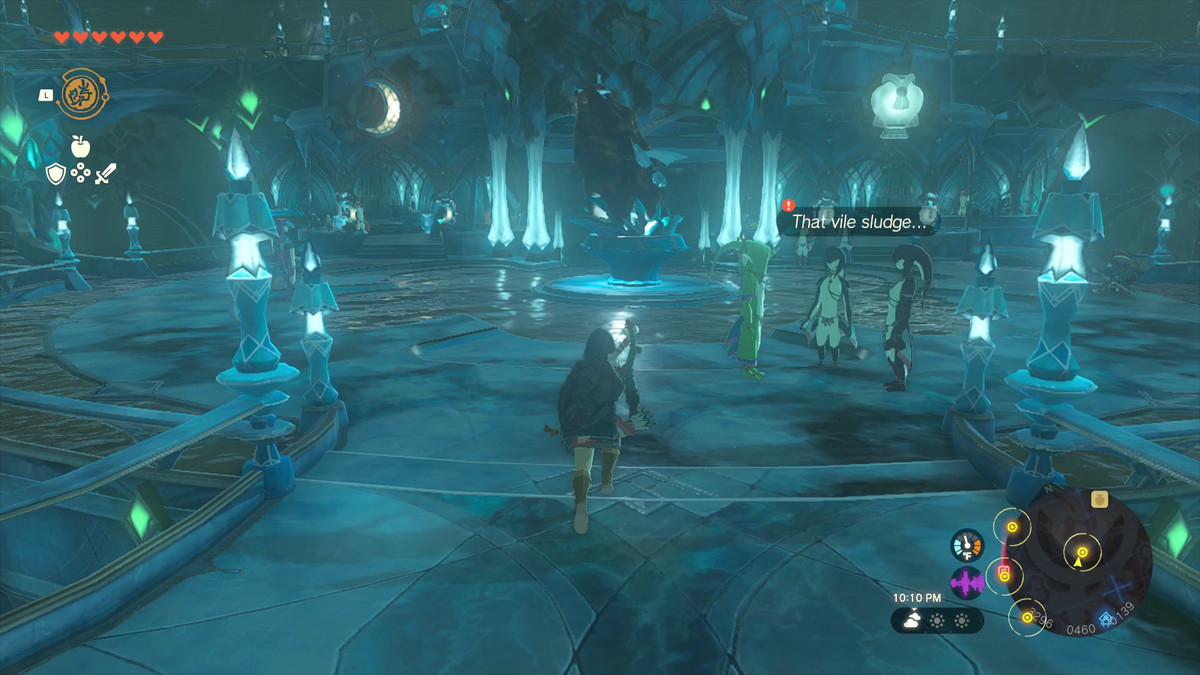 Link si avvicina a tre donne Zora in piedi davanti a una statua infangata in Tears of the Kingdom.  Uno di loro dice 