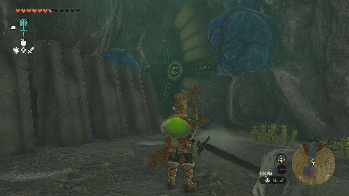 Link guardando un aliante rivelato dietro le rocce blu.