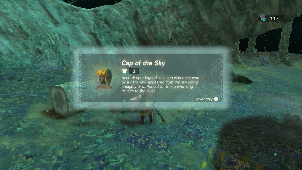 Link apre una cassa contenente il Cap of the Sky vicino a un tronco d'albero in Zelda Tears of the Kingdom.