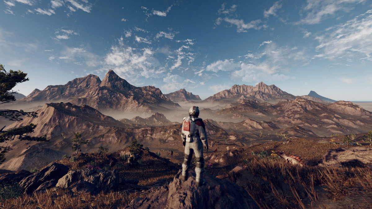 Il personaggio del giocatore si trova su una collina, un'intera catena di montagne che si estende oltre.