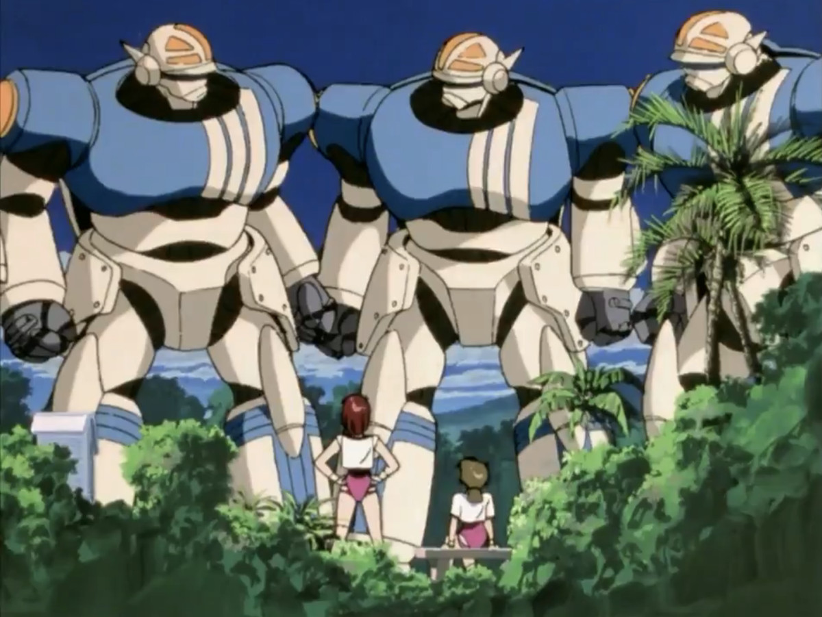 Noriko e la sua amica sono in piedi nei loro abiti da palestra e guardano tre mecha in uno screenshot di Gunbuster